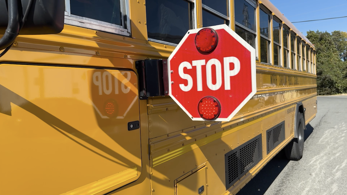  School Bus stop sign extends at bus stop